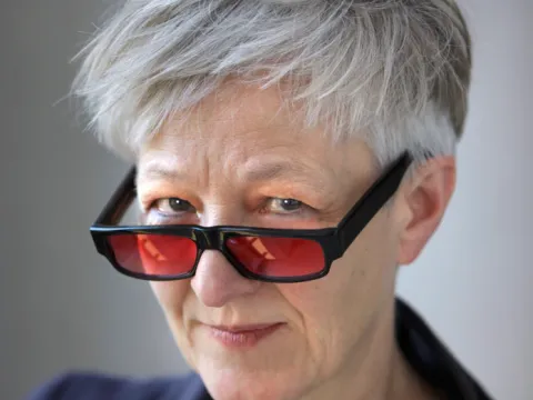 woman with red glasses