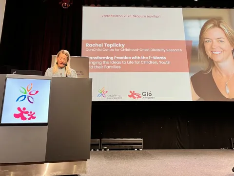 Woman at conference stage