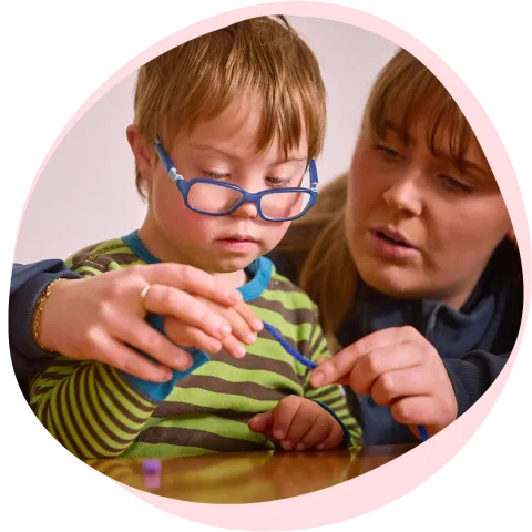 woman helping kid pearl