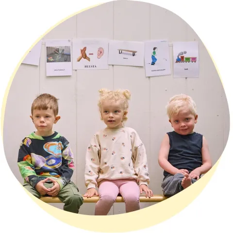 three kids sitting on bench