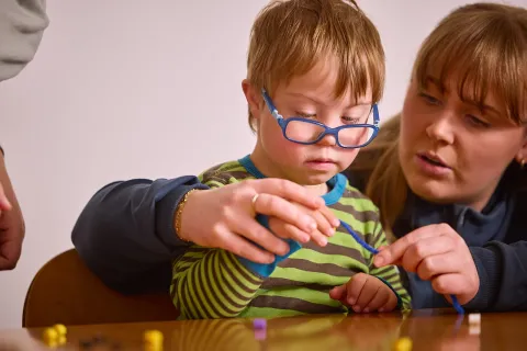 occupational therapist in therapy with a boy