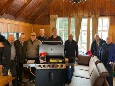 men standing by a bbq
