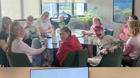 Kids sitting at a table and standing on a stage