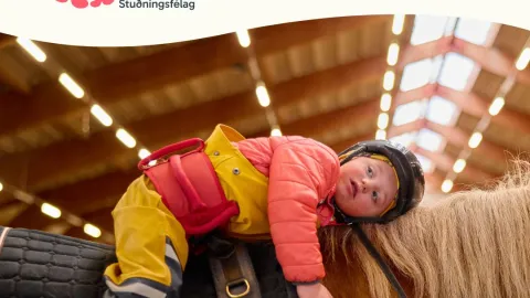 boy on horse back smiling